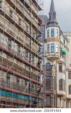 RIGA, LATVIA - JUNE 26, 2014. Reconstruction of building in the Old Town on 26 June 2014.  Old Town is the most popular touristic place in Riga.