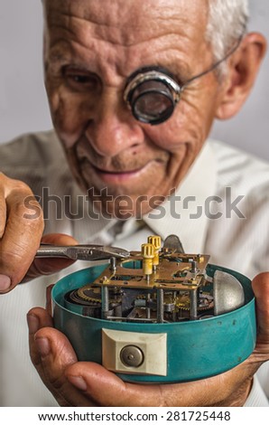 old watchmaker repairing clocks