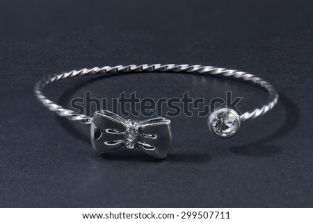 Thin silver bracelet isolated on black