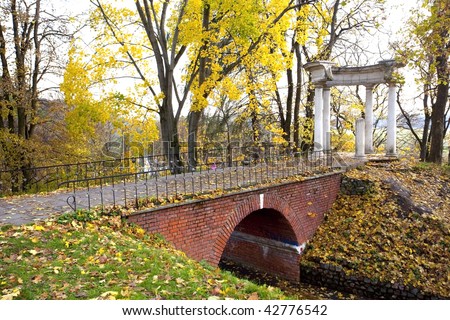 big pink lock on rolling of bridge in autumn park