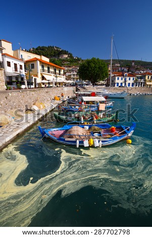 NAFPAKTOS, GREECE,?? MAY 08 2015: (Pine tree pollen in the water.) Boats in the harbour of Nafpaktos, Greece on May 08 2015.