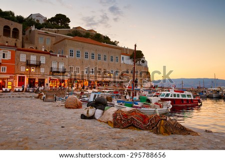 HYDRA, GREECE JUNE 19 2015: Pier, boats and shops on the seafront of Hydra on June 19 2015.