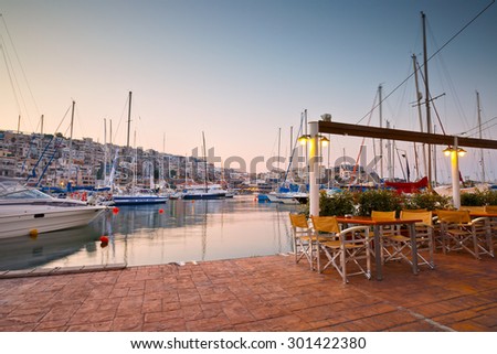 ATHENS, GREECE - JULY 28 2015: Sail boats at the coffee shop of the yacht club in Mikrolimano marina in Athens, Greece on July 28 2015.