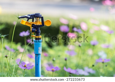 sprinkler head watering the flowers ,close-Up