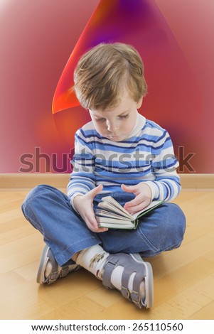 Boy reading book seating on the floor with abstract background