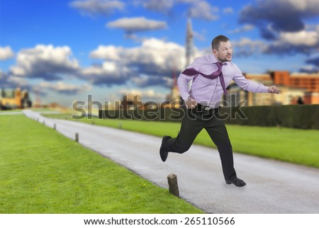 Running businessman in a hurry with modern city in background