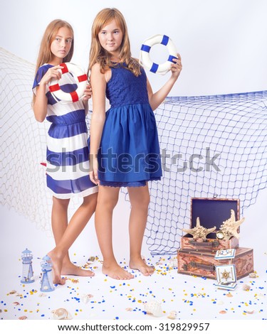 Two beautiful teen girls standing with lifebuoys