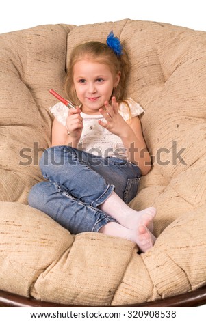 Little girl sitting in armchair isolated on white background