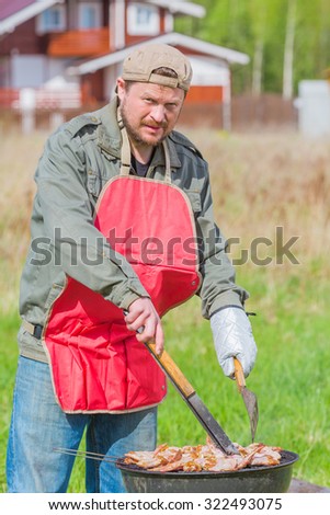 Man preparing barbecue on the lawn bbq