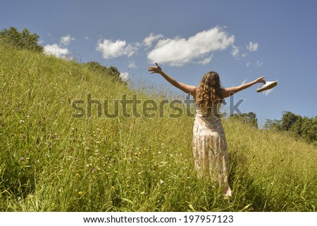 girl relaxing on a green field during early morning sunrise