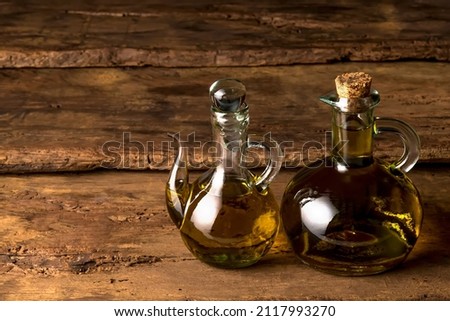 Extra quality cold pressed extra virgin  olive oil, two old glass bottles on a rustic wooden background Stock foto © 