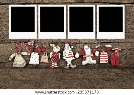 Christmas with four photo frames with Santa Claus dolls on a old wooden background