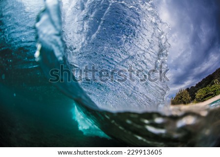 Over and Under a wave breaks on a tropical island