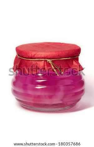 Jelly in a short glass bottle with red paper cap