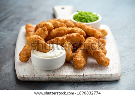 Battered Haddock fish, mini fingers with mashed peas, tartar sauce on white wooden board Stockfoto © 