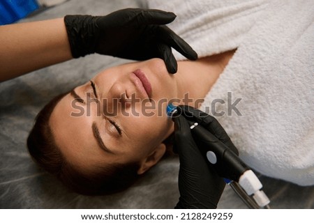 Face skin care. Close-up of woman getting facial hydro microdermabrasion peeling treatment at cosmetic beauty spa clinic. Hydra vacuum cleaner. Exfoliation, rejuvenation and hydratation. Cosmetology. Foto stock © 