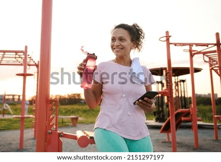 Similar – Image, Stock Photo Slim sportswoman drinking water in park