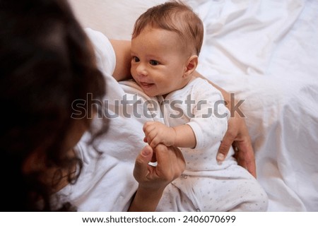 Similar – Image, Stock Photo Mom breastfeeding at home