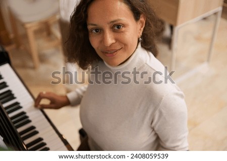 Similar – Image, Stock Photo Smiling woman playing piano in living room