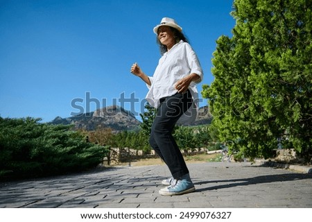 Similar – Image, Stock Photo Serene woman dancing on terrace