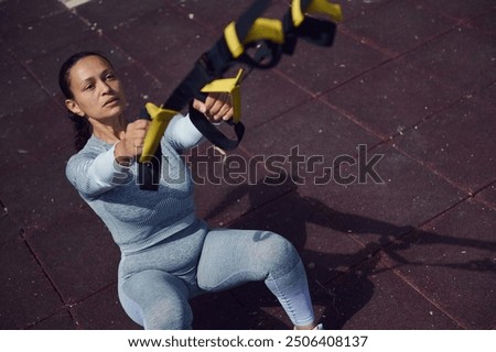 Similar – Image, Stock Photo Woman with resistance band on wrists working out at home