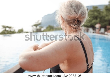Similar – Image, Stock Photo fit senior lady dressed in black by the lake