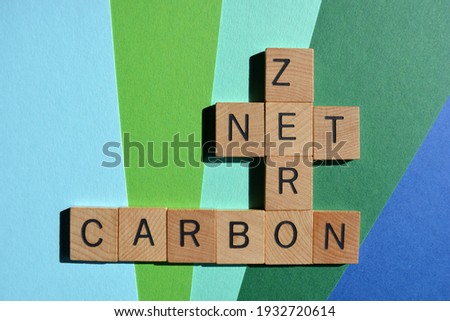 Net, Zero, Carbon, words in wooden alphabet letters isolated on blue and green background