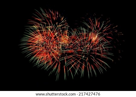 Colorful fireworks in the form of heart. Red tone.