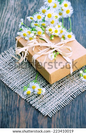 bouquet of daisies and a gift