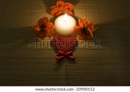 Candle surround by flowers and heart with sign \