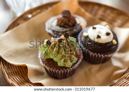 mini cup cake set on vintage wooden background focus on one point and shallow depth of field
