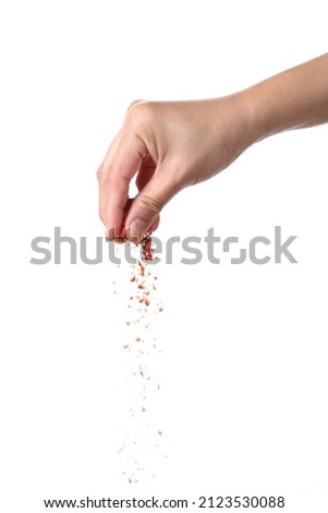 Hand sprinkling cayenne pepper isolated on white background Stock foto © 