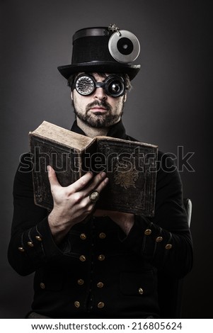 old book  man in steam punk outfit reading a old book, wearing hat and sunglases