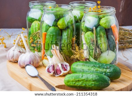 jars of homemade preserves with pickled cucumbers