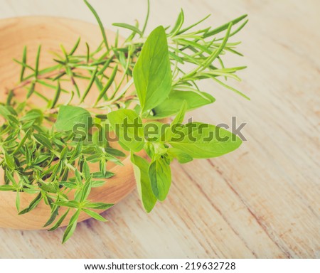 vintage photo of fresh herbs on a wooden table