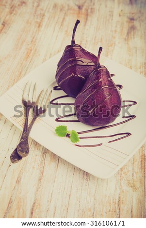 Vintage photo of pears cooked in red wine covered doused chocolate