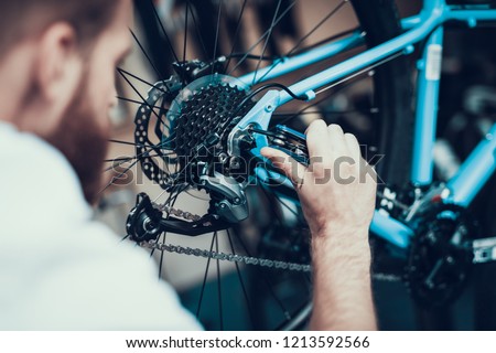 Image, Stock Photo Bearded mechanic repairing wheel of bicycle