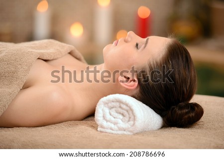 Portrait of Fresh and Beautiful brunette woman taking head massage isolated on background spa salon