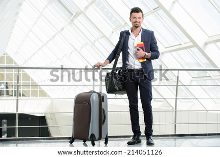 Handsome businessman waiting flight departure time at airport