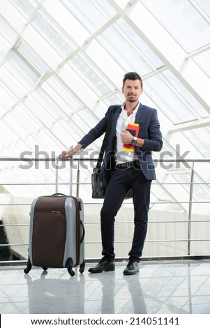 Handsome businessman waiting flight departure time at airport