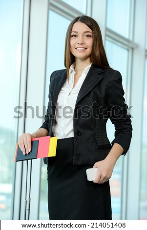 Business woman on plane tickets waiting for your flight at the airport