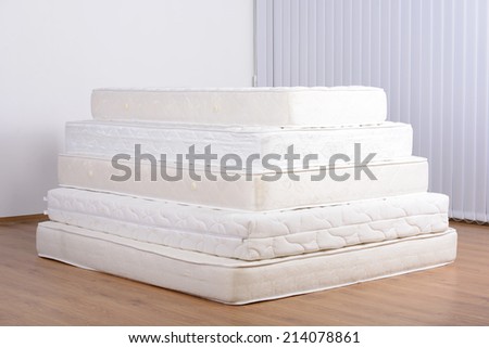Many mattress in a pyramid in the room