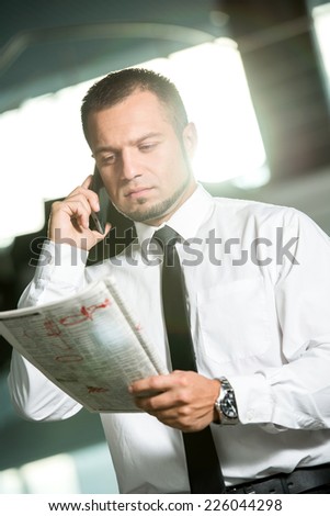 Unemployed man is looking for a job in the newspaper and calling.