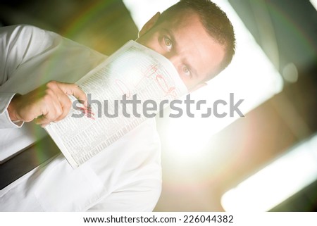 Young man with the newspaper, he is looking for a job.
