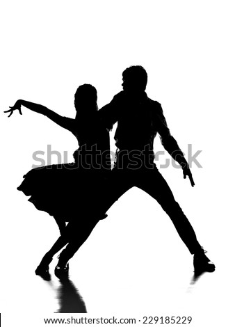 Silhouette of handsome couple of professional dancers on the grey background. Passionate dance.