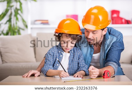 Young father teaches his little son tinkering.