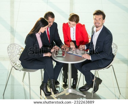 Portrait of several business people are planning work at round table.