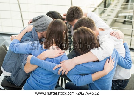 Circle of trust. Group of people are sitting embracing in circle  and supporting each other.