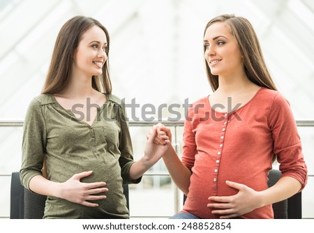 Maternity concept. Two smiling pregnant women at the meeting at antenatal class.