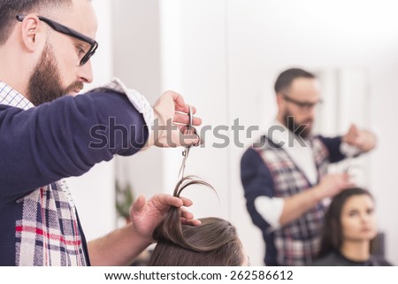 Close-up hairdresser cutting hair a woman in hairdresser salon.